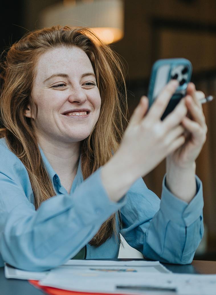 Woman using smart phone at table-card