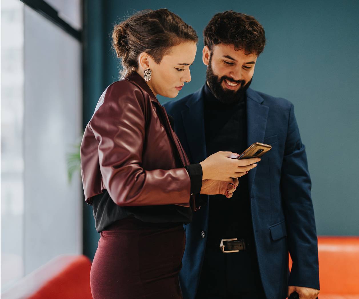 Two professionals engaging over a smart phone screen-square