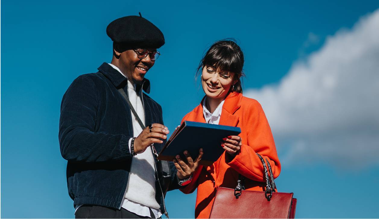 Two young entrepreneurs working on tablet outside-rectangle