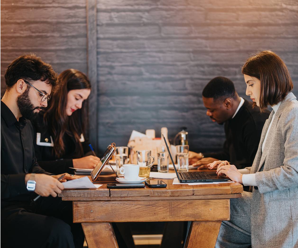 Business colleagues working together on laptops
