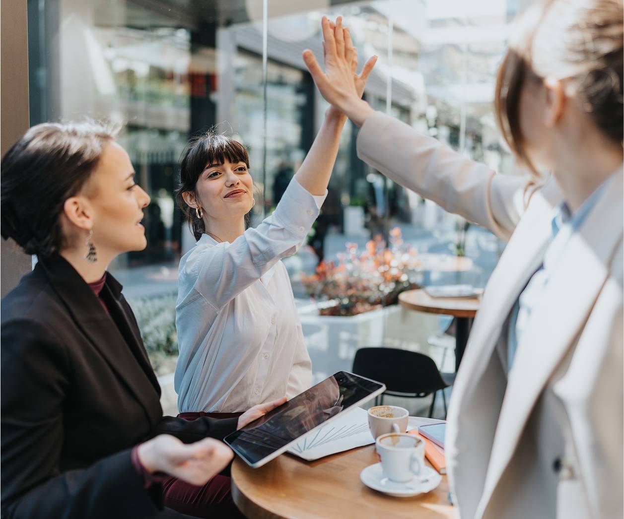 Business woman doing a high-five over table