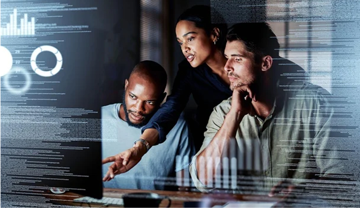 Team of three analysing data on screen