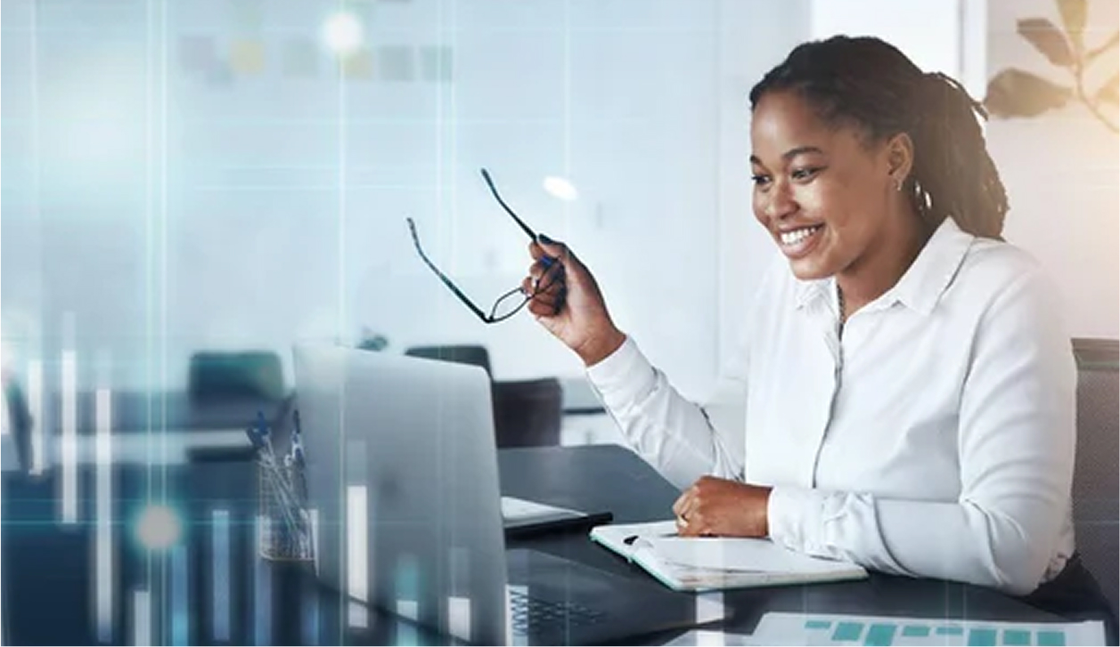 Woman holding glasses looking at laptop