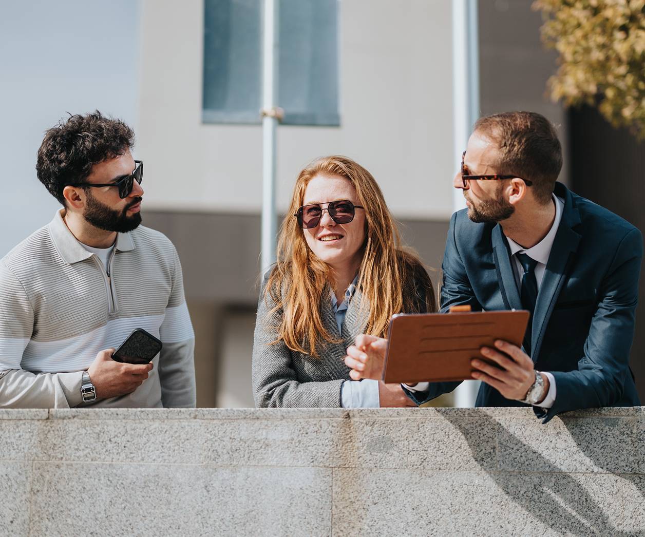 Group of three people collaborating outside