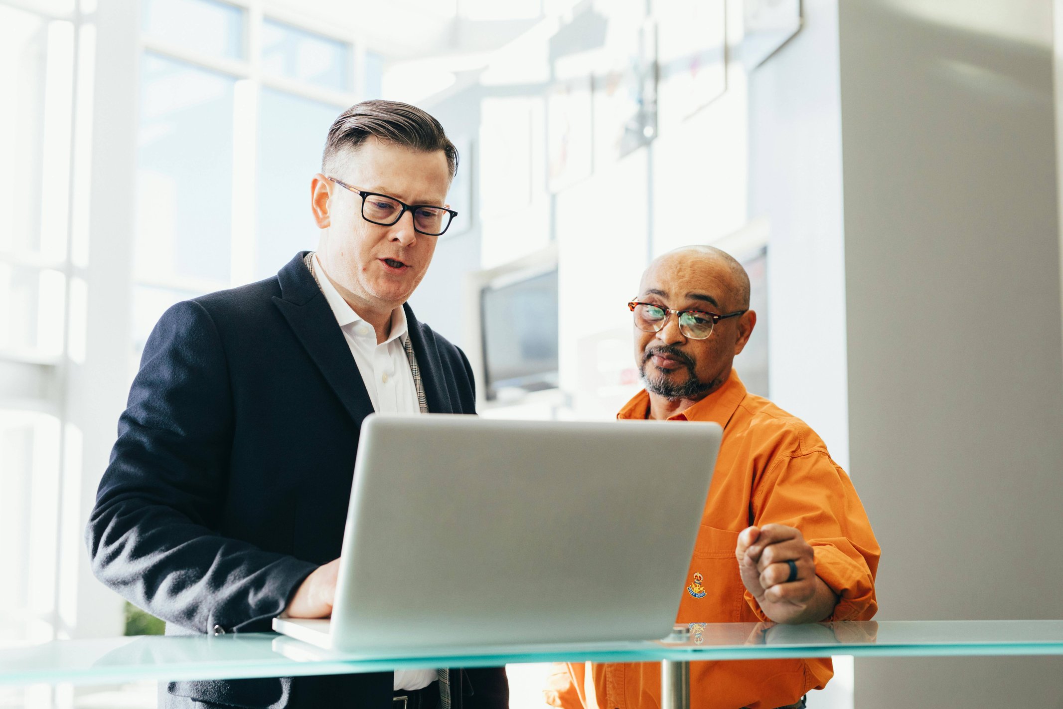 Two colleagues looking at a laptop